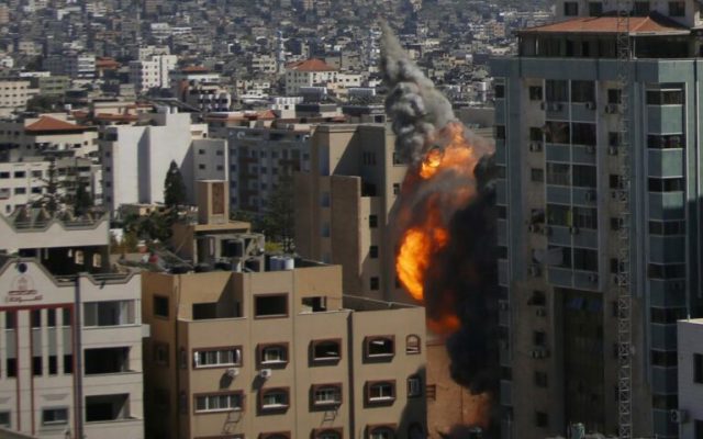 Rocket from Gaza kills 2; Israel topples 6-story building